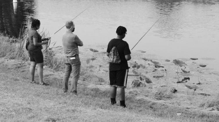Oklahoma Department of Human Services Director Justin Brown awaits the next catch as children in foster care were treated to an evening of fishing. (Don P. Brown/ODWC)