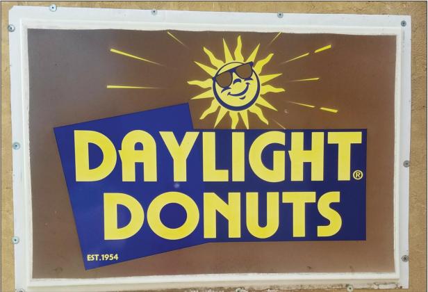 Sign for Daylight Donuts on side of building at 112 N. Boadway, waiting on new front sign
