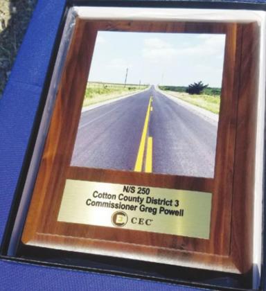 Shon Richardson of CEC Corporation presented this plaque to District 3 County Commissioner Greg Powell