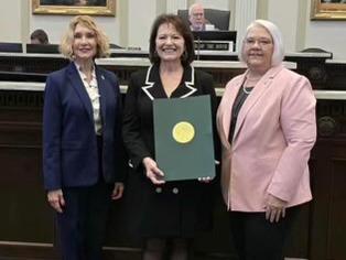 Dr. Delilah Calfy Joiner Martin (center) received a Certificate of Recognition from the Oklahoma House of Representatives for being selected as 2024 Oklahoma Mother of the Year. American Mothers representatives Marilyn Stark and Tammy West were on hand for the presentation.