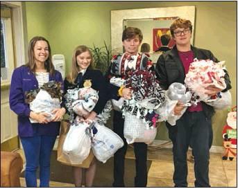 Taylor Gebhart (left), senior; Caleb Robinson, sophomore; and Jaden Gibson, eighth grade, delivered the 16 blankets to Hospice of Wichita Falls on Thursday, Nov. 21