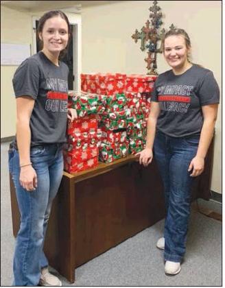 Katelyn Laminack, senior, (left) and Miya White, senior, delivered the 22 shoeboxes to First Baptist Church in Burkburnett, Texas.