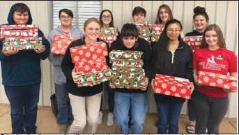 Students in agricultural education classes donated items, wrapped and packed shoeboxes for the community service project.   Front row from left: Maddison Rivers, senior; Bryan Smith, sophomore; Elena Davila, sophomore; and Taylor Gebhart, senior. Back row: Christopher Phelps, sophomore; Payton Benson, junior; Moriah Mullins, sophomore; Caleb Robinson, sophomore; Alexis Berry, junior; and Kelsi King, sophomore.
